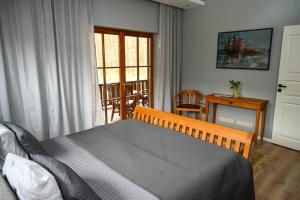 a bedroom with a bed and a table and a window at Domus Revado in Birštonas +30 photos