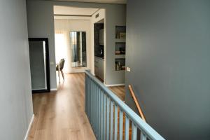 a hallway with a stairway with a blue wall at Domus Revado in Birštonas