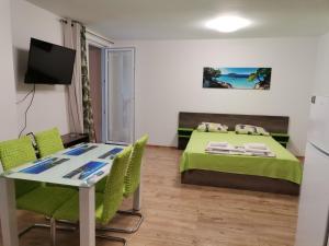 a small room with a bed and a table and chairs at Path ways to the Sea -Пътека към морето in Primorsko