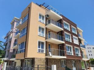 a tall building with balconies on the side of it at Path ways to the Sea -Пътека към морето in Primorsko