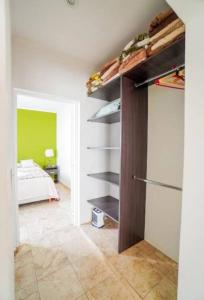a room with a bed and a closet with shelves at Apartamento Lo de Ana in Termas de Río Hondo