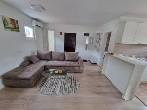 a living room with a couch and a table at Nada-S in Soko Banja