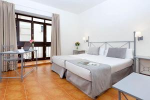 Postel nebo postele na pokoji v ubytování Sercotel Toledo Imperial + 8 fotografií