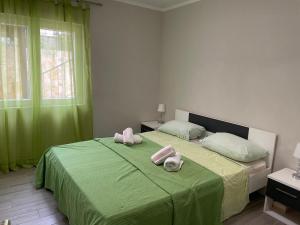 a bedroom with two beds with green sheets and pink towels at Villa 4 Princesses in Vela Luka +207 photos