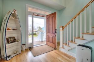 a hallway with a door and a mirror at Elanora by Carolina Beach Realty in Kure Beach