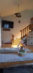 a living room with a couch and some stairs at Къща за гости Брязово in Ribarica
