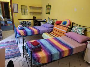 a room with three beds and a desk at Bed-Letto-Cama in Shared Room Camera Condivisa in Naples