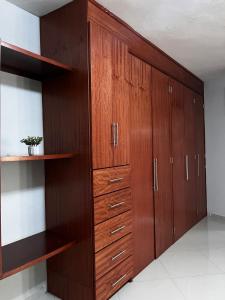 a large closet with wooden cabinets in a room at Hotel Boutique Blue Diamond in Tepatitlán de Morelos +2 photos