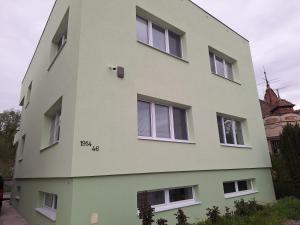 a white building with windows on the side of it at Apartmán Stummerova in Topoľčany