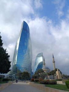 a group of glass buildings in a city at Хорошем месте находится, улица Иззет Небиев 6-22 in Baku +14 photos