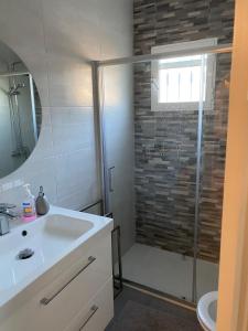 a bathroom with a shower and a white sink at Casa Venetti , stylish flat in Villa Martin in Orihuela Costa