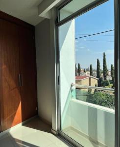 an empty balcony with a large glass window at Hotel Boutique Blue Diamond in Tepatitlán de Morelos