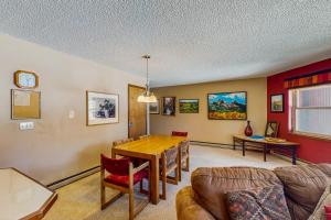 a living room with a table and a couch at Tyra I A2D in Breckenridge