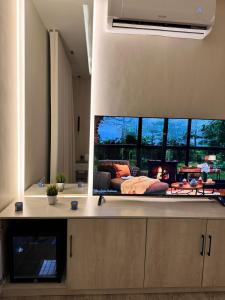 a living room with a flat screen tv on the wall at Quiet Studio with Smart Entry Roses in Jeddah