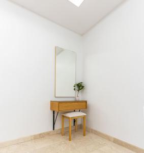 a dressing table with a mirror and a stool at وحدات الردسي الفندقيه in Jeddah +3 photos