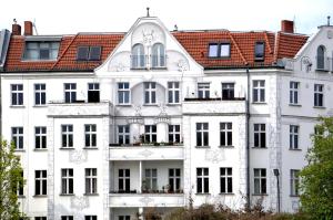 a white building with a red roof at Poets Place Design Apartment in Kreuzberg - space for 8 people max 6 adults in Berlin