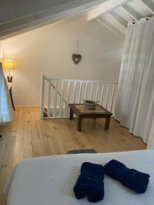 a bedroom with a bed and a table in a room at Crystal Beach, vue mer, accès direct plage et piscine, clim in Sèze