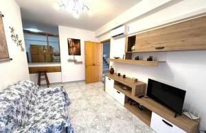 a living room with a tv and a couch at Nelly's house in Terrasini