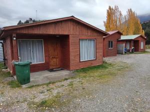 a small cabin with a green trash can in front of it at Cabañas Edén Milenaria in El Cerrillo