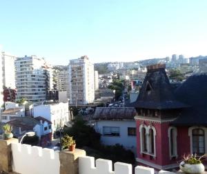 a red building with a black roof in a city at Hotel HC94 in Viña del Mar