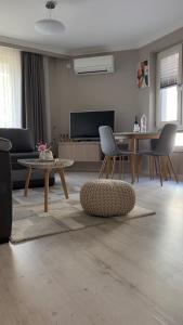 a living room with a couch and a table at Luxury Stays Kapana Plovdiv in Plovdiv