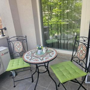 a patio table with two chairs and a table with a plate at Luxury Stays Kapana Plovdiv in Plovdiv