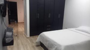 a bedroom with a bed and a black cabinet at Apartamento 5 in Leticia
