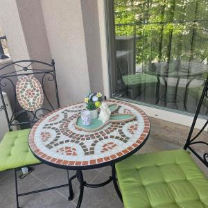 a table with a plate of food on a patio at Luxury Stays Kapana Plovdiv in Plovdiv