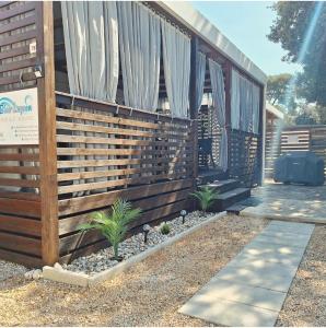 dom z drewnianym płotem i roślinami w obiekcie Mobile home Blue Lagoon 785 w Biogradzie na Moru