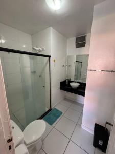 a bathroom with a shower and a toilet and a sink at Pousada Mananauê Beach in Porto De Galinhas