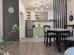 a kitchen and dining room with a table and chairs at W Apartments in Kotor