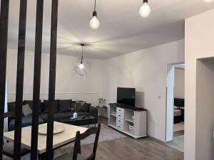 a living room with a couch and a table and a tv at W Apartments in Kotor