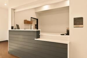 a counter in a room with a mirror at LivAway Suites Missoula in Missoula