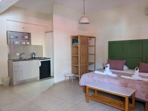a bedroom with a bed and a kitchen with a sink at Pension Irene in Sougia