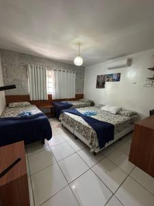 a hotel room with two beds in a room at Pousada Mananauê Beach in Porto De Galinhas