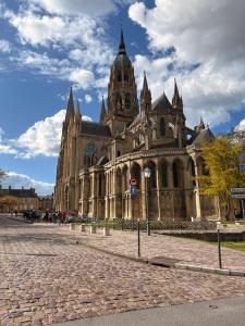 a large building with a tower on top of it at Le Nid dHistoire avec vue sur la cathédrale in Bayeux