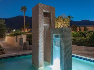 a swimming pool with a water fountain in a building at Downtown Winner at Plaza Villas by ACME House Company in Palm Springs