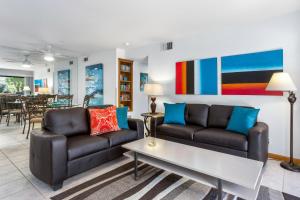 a living room with two couches and a table at Downtown Winner at Plaza Villas by ACME House Company in Palm Springs
