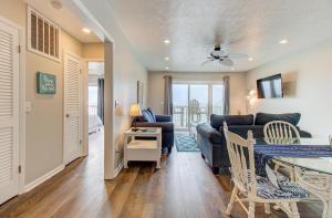a living room with a couch and a table at Ocean Dunes 1704 by Carolina Beach Realty in Kure Beach