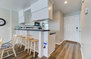 a kitchen with a counter and stools in a room at Ocean Dunes 1704 by Carolina Beach Realty in Kure Beach