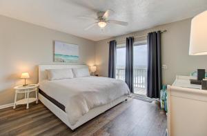 a bedroom with a bed and a ceiling fan at Ocean Dunes 1704 by Carolina Beach Realty in Kure Beach