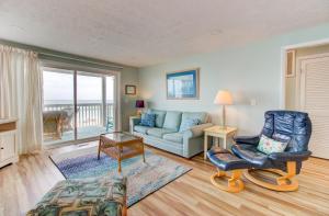 a living room with a couch and a chair at Ocean Dunes 2101A by Carolina Beach Realty in Kure Beach