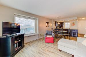 a living room with a large flat screen tv at Ocean Dunes 2124C- Bella Vista by Carolina Beach Realty in Kure Beach +50 photos