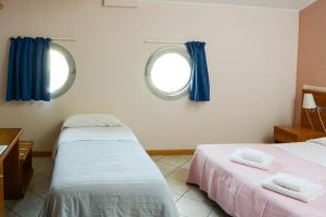 Postel nebo postele na pokoji v ubytování Albergo Meublè Abatjour