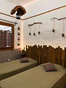 a bedroom with two beds and a wall with lights at Mírame Canarias in Vecindario +47 photos