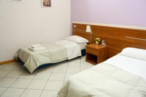 Postel nebo postele na pokoji v ubytování Albergo Meublè Abatjour