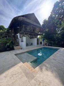 a villa with a swimming pool and a building at City Escape Casa Mariguana in Turbaco