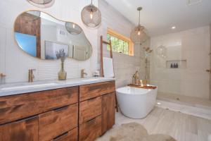 a bathroom with a tub and a sink and a mirror at Eagle's View in Dadeville +68 photos