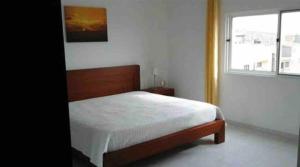 a bedroom with a bed and a window at Casa Ramanda in Tarrafal