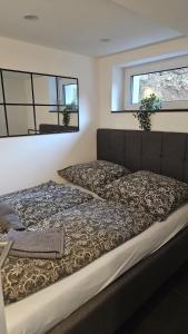 a bed in a room with two windows at Geschäfts- und Monteurs Apartment 2 SZ in Königswinter